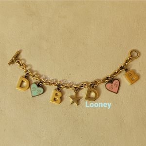 Dooney Bourke Goldtone D B Charm Bracelet